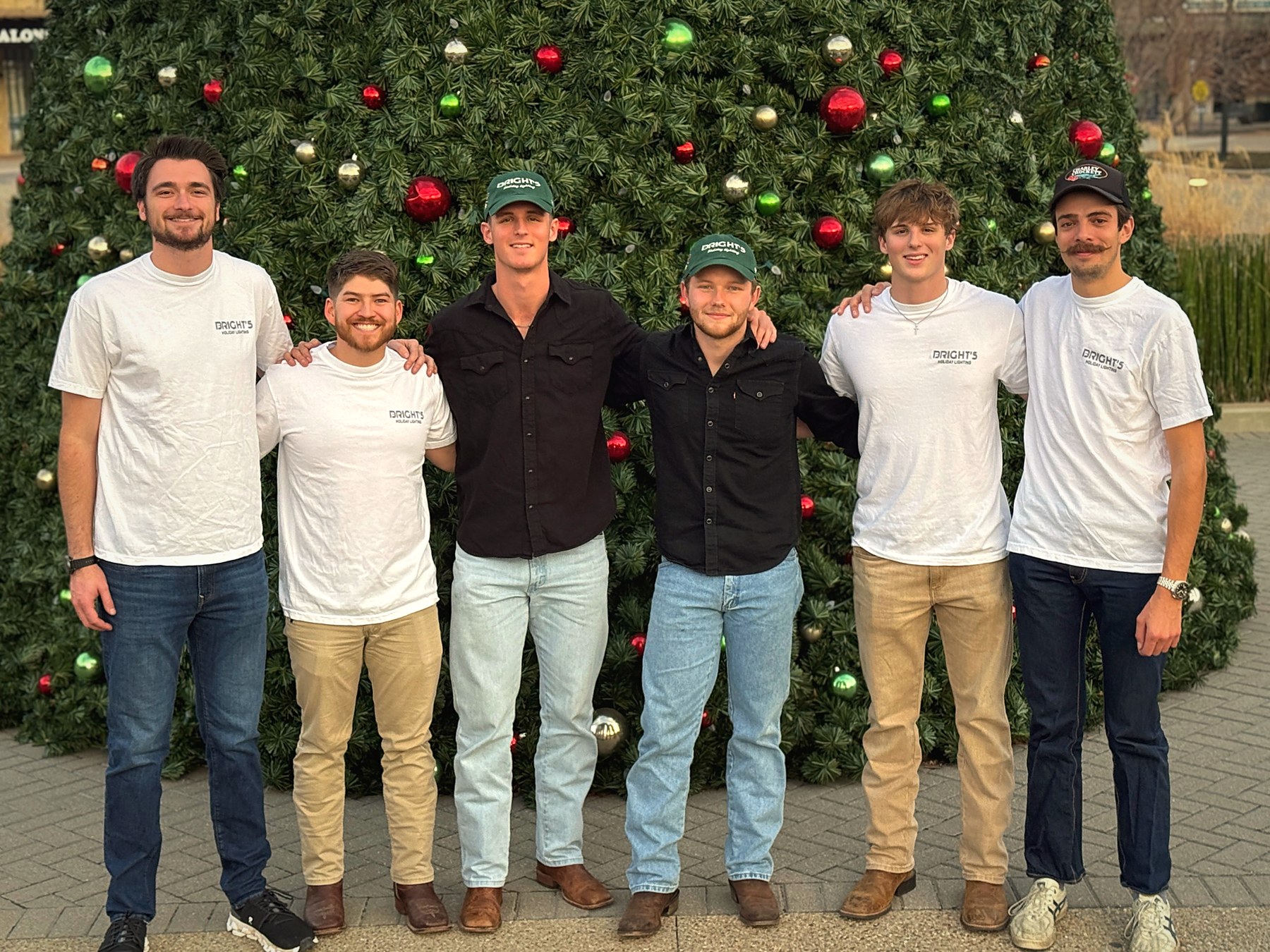 The Bright's crew in front of a Christmas tree