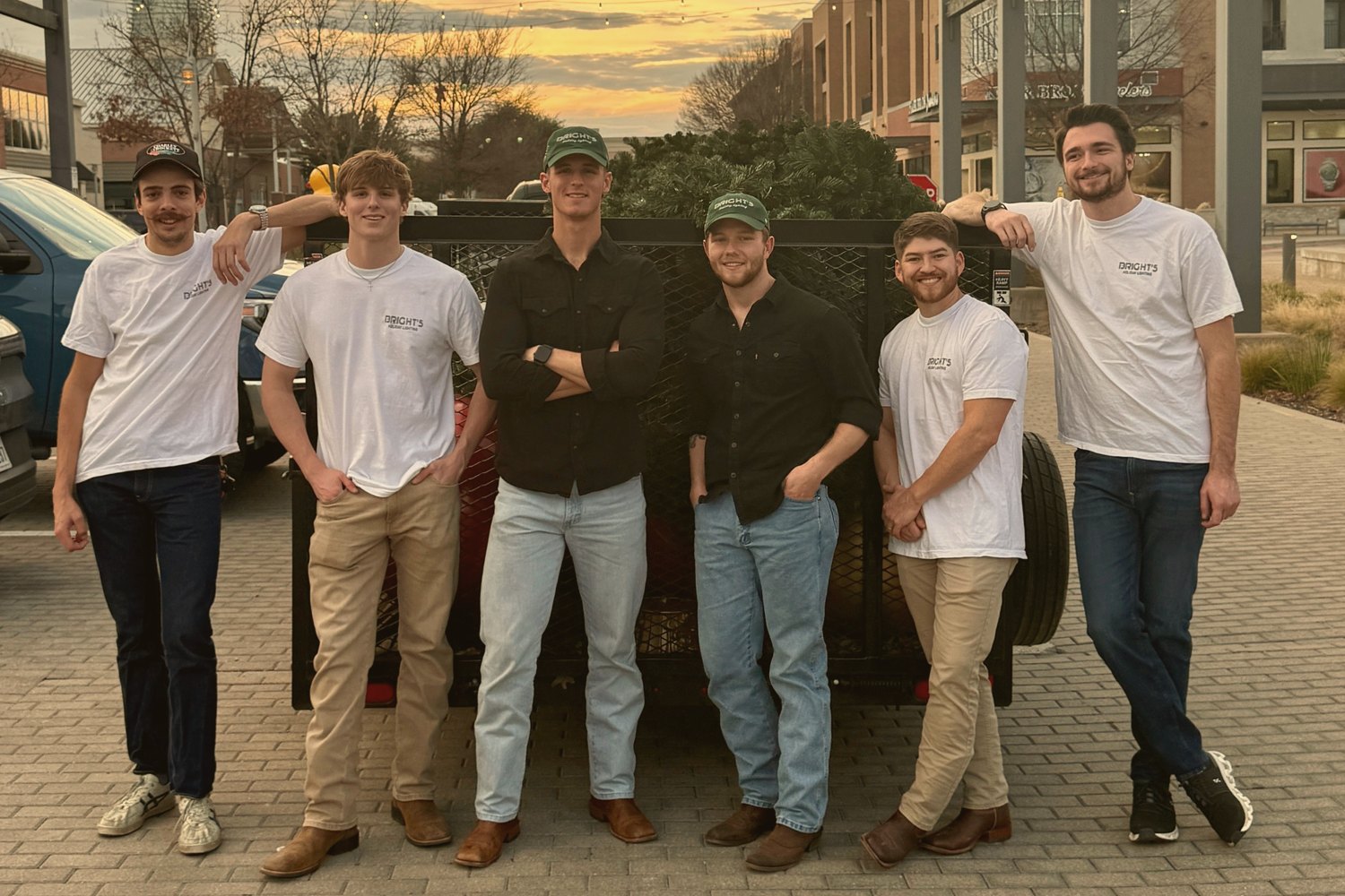 The Bright's crew in front of a trailer of fresh garland