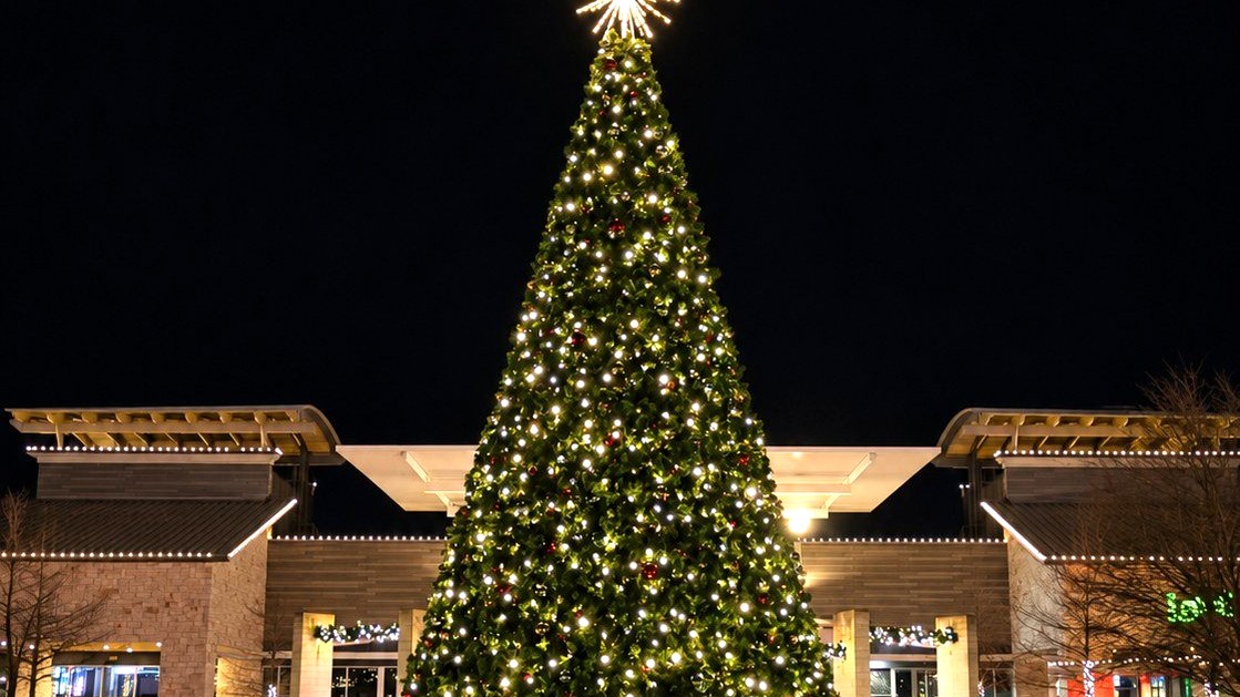 Large lit Christmas tree in a shopping center plaza