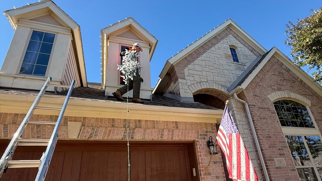 Bright's crew installing lights on a two-story home