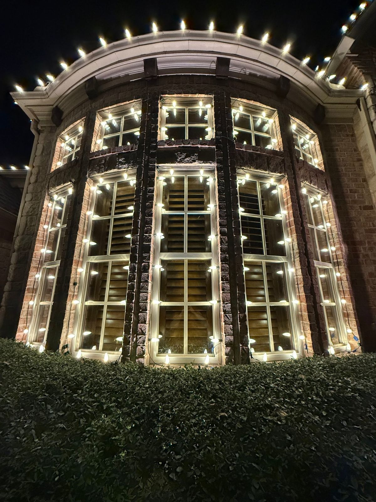 Curved bay windows outlined in warm white lights